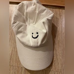 Three baseball caps with a smiley face